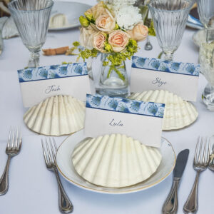 Beach wedding table setting with shell place cards